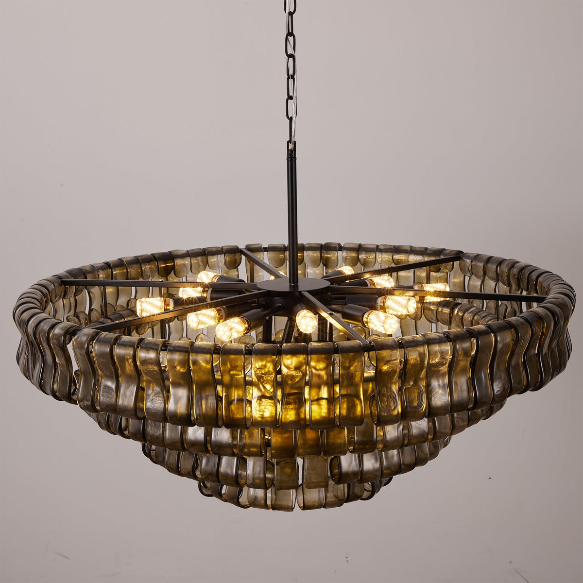 Seen from below, this smoke-grey Clérachic chandelier shows a black spoke frame and exposed warm bulbs inside the glass rim.