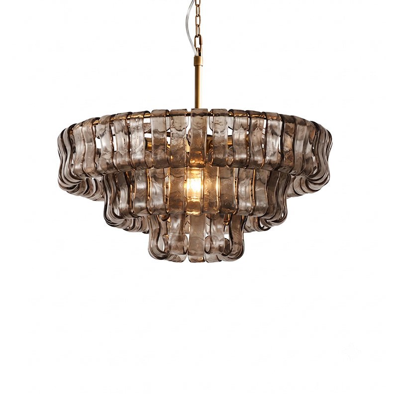 Three tiers of smoke-grey glass tiles on this Clérachic chandelier, with one warm bulb glowing at the centre, on white.