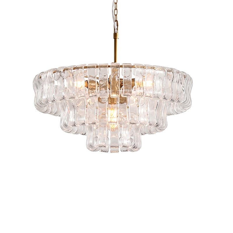 Clear glass chandelier from Clérachic with a brass stem and three rounded tiers, on a white background.