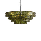 Compact green glass chandelier from Clérachic, with a black stem and a soft glow inside, on a white backdrop.