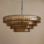 Deep brown glass in five rounded tiers on this Clérachic chandelier, hung from a black chain against a taupe backdrop.