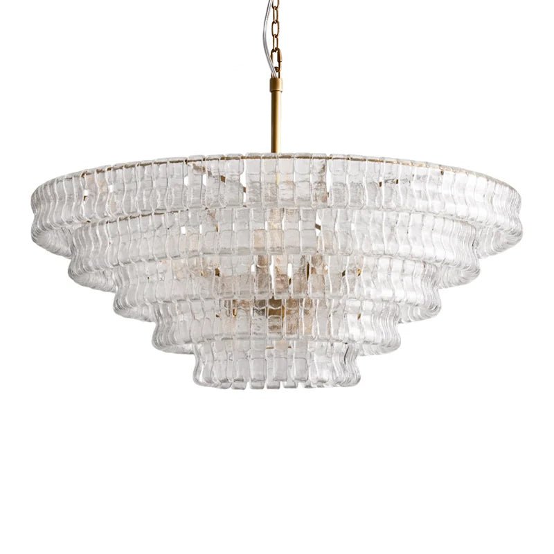 A wide clear-glass chandelier from Clérachic, with a brass stem and five stepped tiers, shown on white.