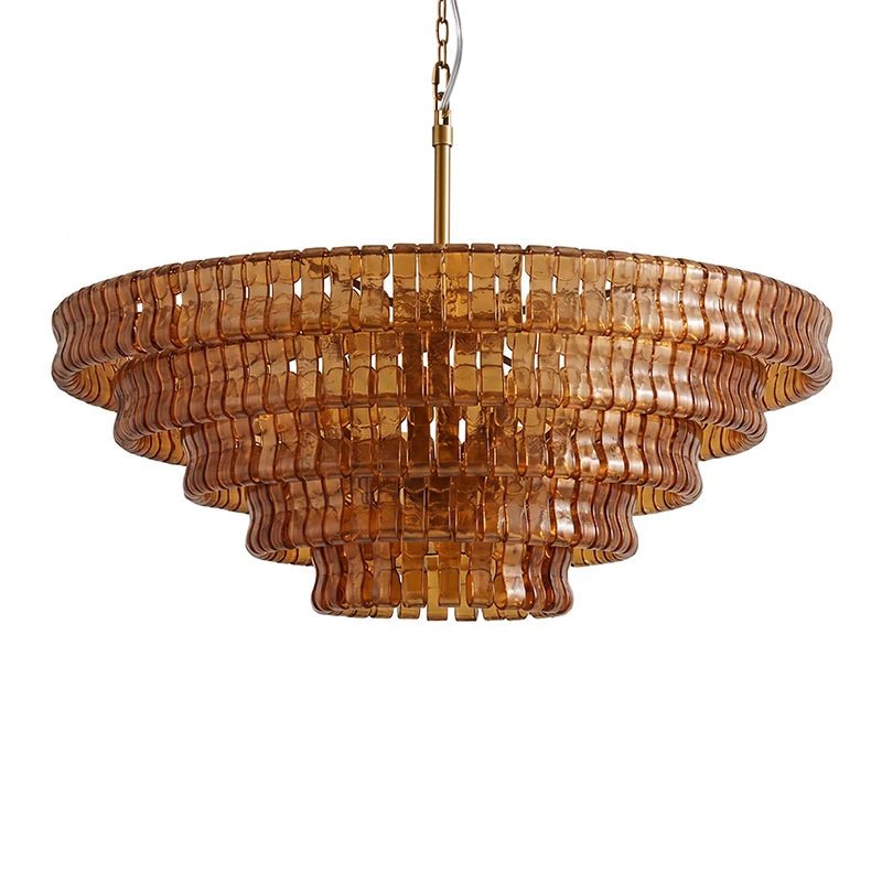 Warm amber-brown glass and a brass stem on this Clérachic chandelier, with five wide tiers, on a white backdrop.