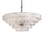 Unlit and on a white background, this clear glass Clérachic chandelier has a black stem and five wide tiers.
