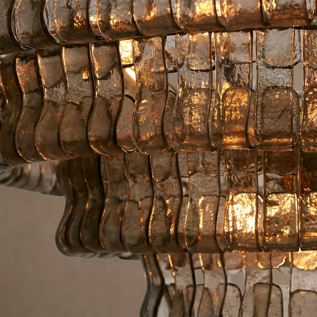 Close view of smoky bronze glass strips on this Clérachic chandelier, a warm glow shining through the ripples.