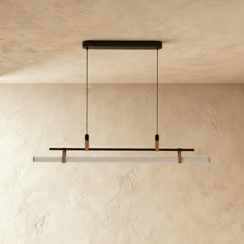 Clérachic black linear pendant switched off, its opal tube held by tan straps beneath a thin bar and an oval canopy.