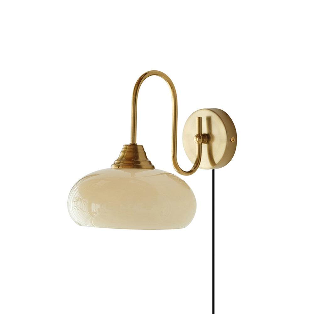Clérachic glass wall lamp in copper with a beige dome and a black plug-in cord, shown unlit on white.