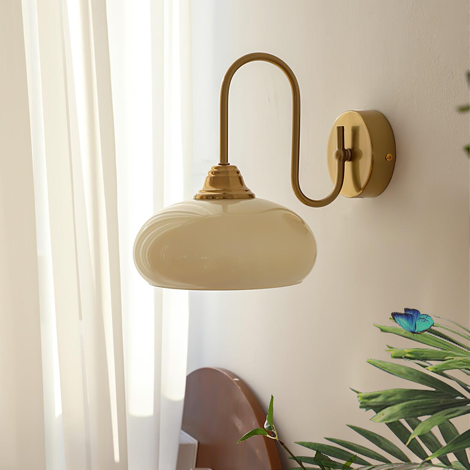 Clérachic glass wall lamp, copper and beige, hardwired beside sheer curtains, a plant, and a blue butterfly.