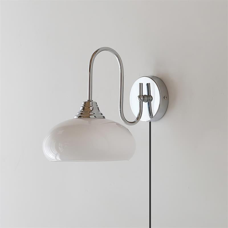 Clérachic glass wall lamp, chrome arm and white glass, plug-in cord hanging from the round wall plate.