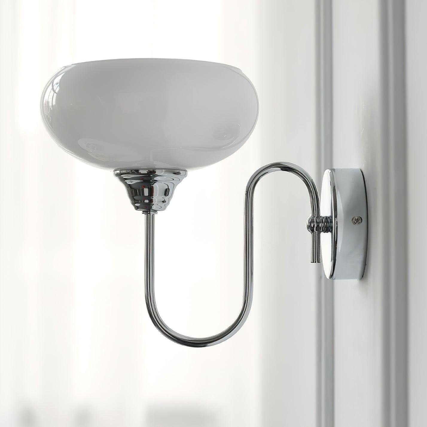 Clérachic glass wall lamp in chrome with white glass, hardwired on a wall with vertical paneling.