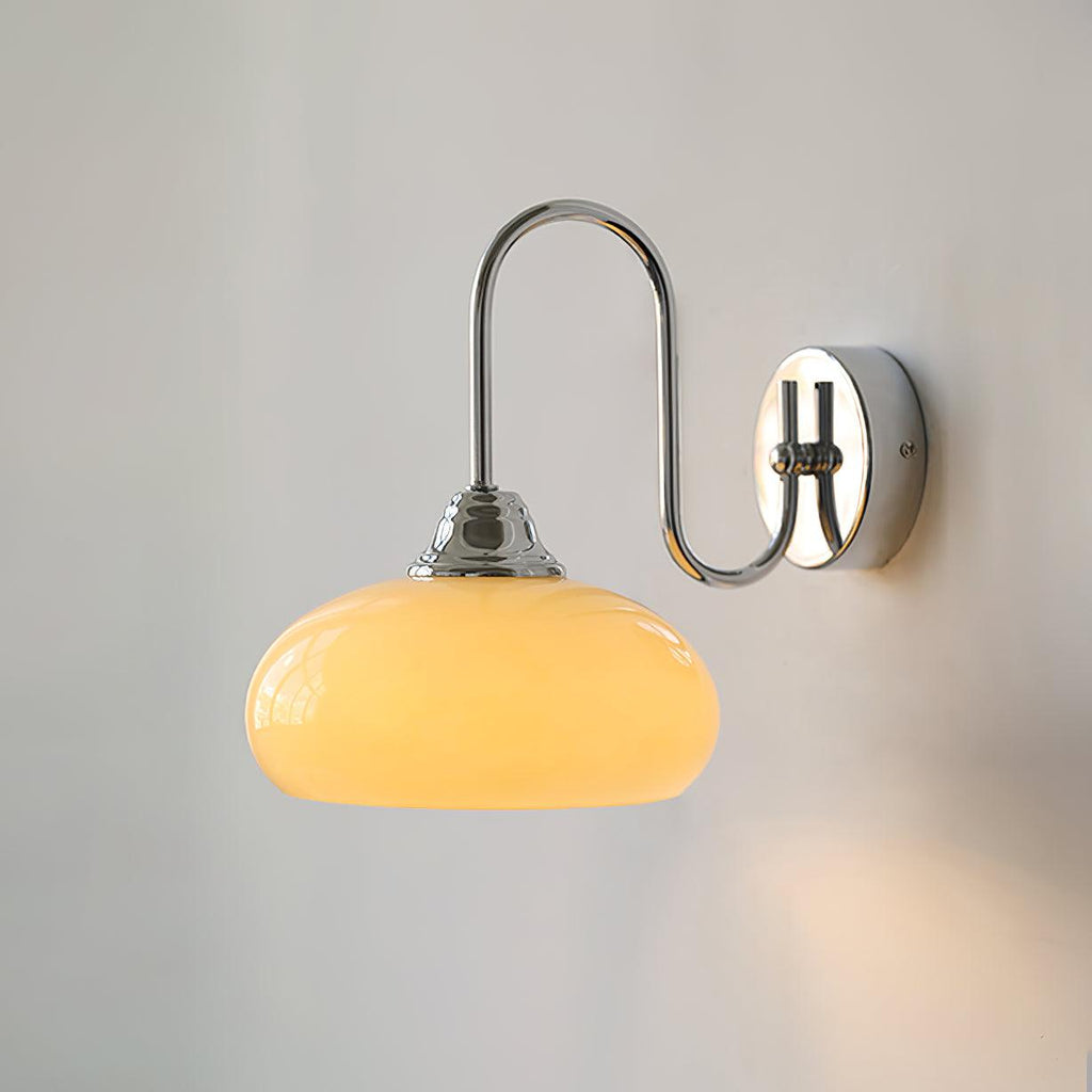 Clérachic glass wall lamp in chrome and beige, hardwired and lit, a glow catching the round chrome plate.