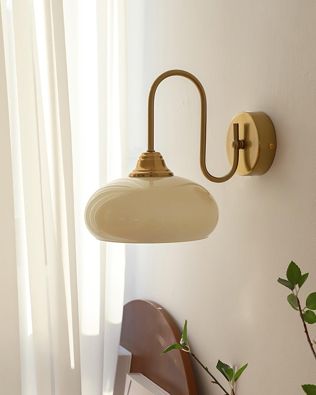 Clérachic glass wall lamp in copper and beige, hardwired in daylight above a rounded wood headboard.