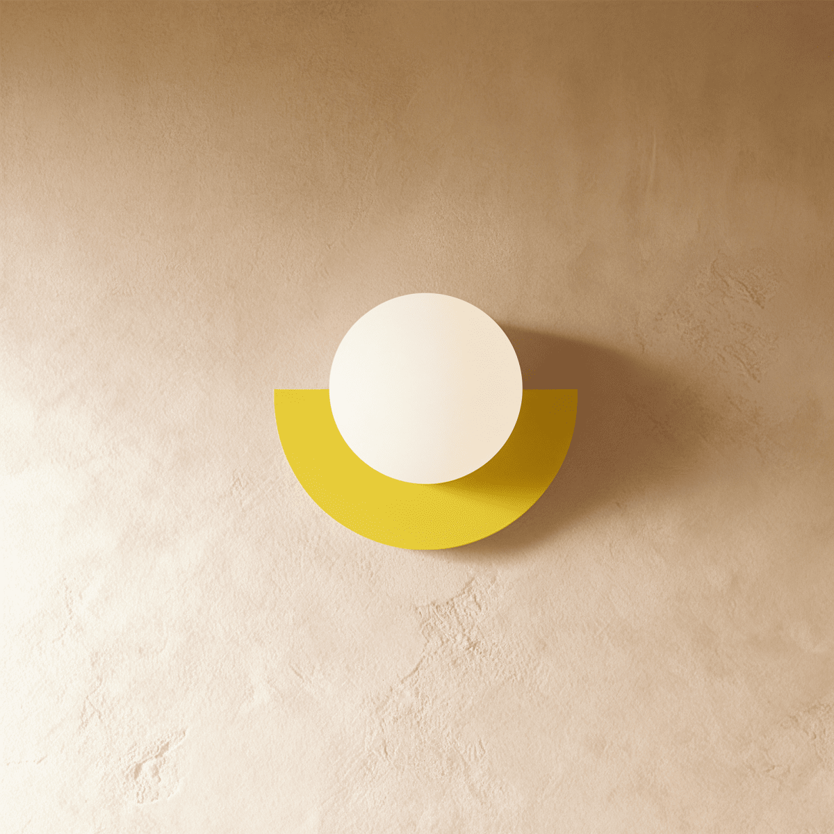 Clérachic opal glass globe on a yellow half-moon metal back plate, mounted on a warm limewash plaster wall.