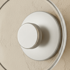 Close-up of the Clérachic glass uplight wall bowl in Transparent, showing its white centre knob and clear glass rim.