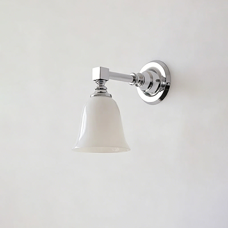 Chrome Clérachic wall light with a smaller flared bell-shaped white glass shade, switched off, on a pale grey wall.