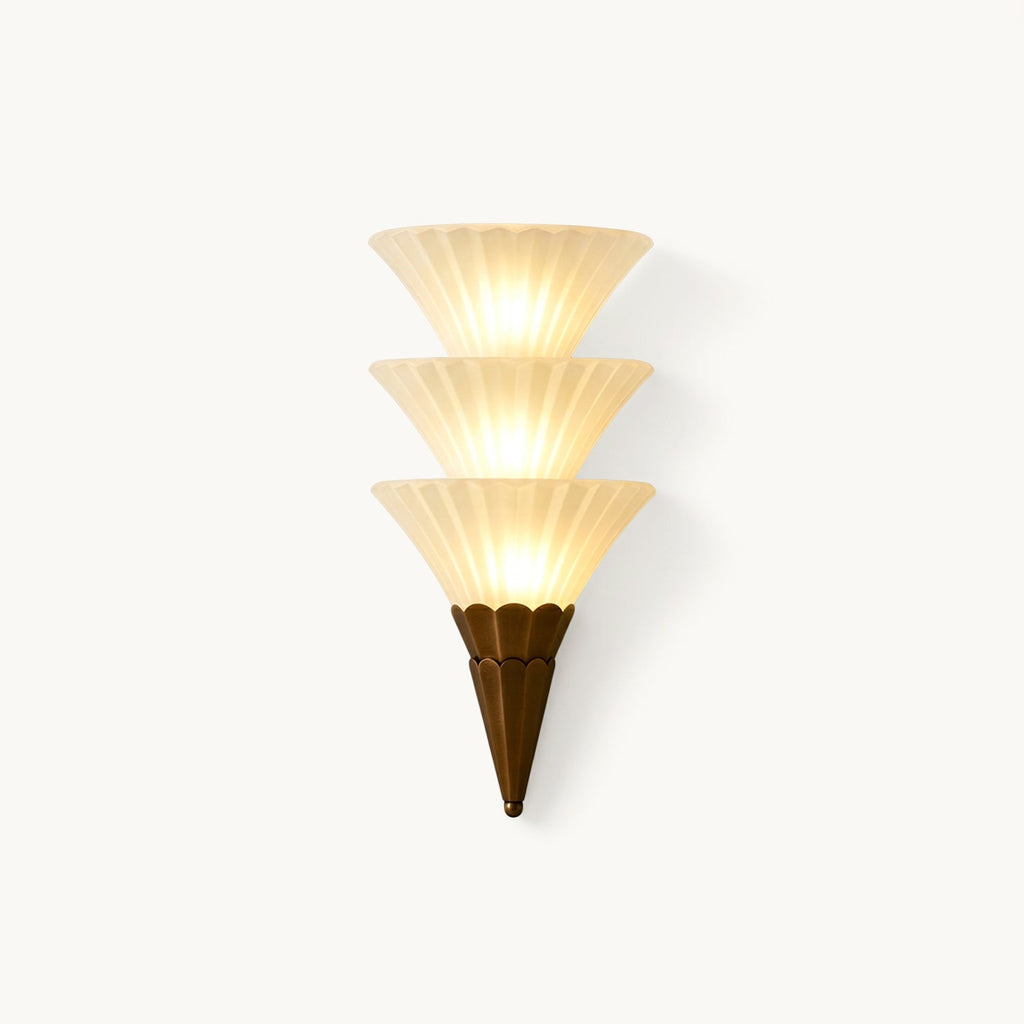 Clérachic wall sconce with three stacked ribbed white glass cones above a brown pointed base, lit, on a plain white backdrop.
