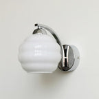 Clérachic chrome lantern wall sconce, white ribbed glass hanging from a curved arm on a circular plate.