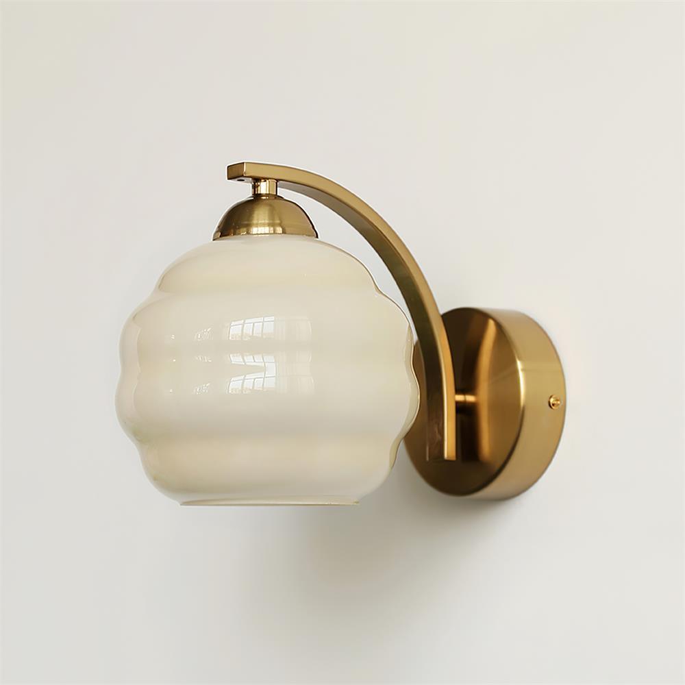 Clérachic gold wall sconce in side profile on a white wall, the beige lantern shade showing its ribbed glass.