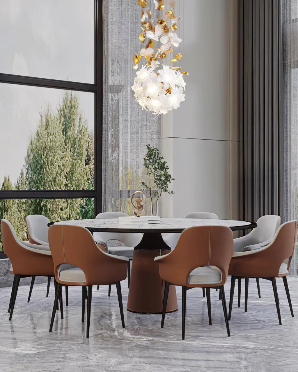 Over a round marble dining table with tan leather chairs, a small round Clérachic chandelier of white petals hangs near a tall window.