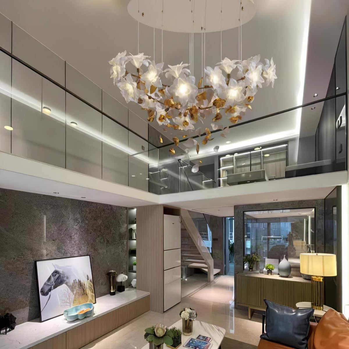 Spread wide beneath a white ceiling, this Clérachic chandelier hangs in a double-height living room with a glass balcony and sideboard.