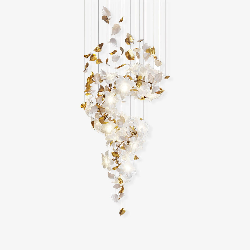 Unlit Clérachic chandelier on a pale grey backdrop, brass leaves and white petals gathered in a loose S along its many suspension cords.
