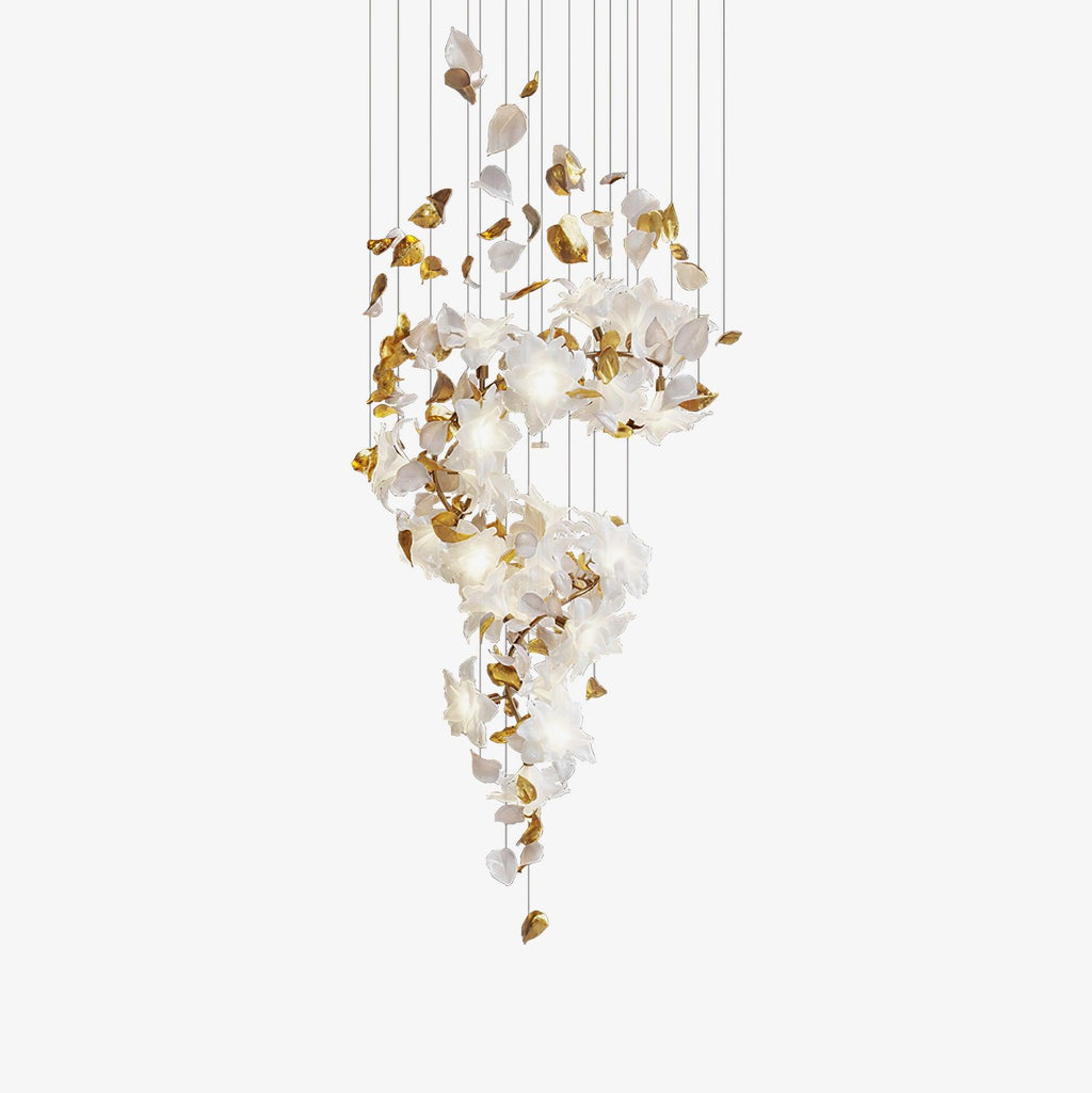 Unlit Clérachic chandelier against a pale backdrop, its white petals and brass leaves winding down a spread of thin suspension cords.