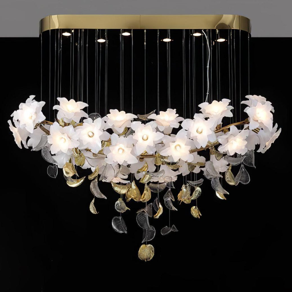 A long brass canopy with small spotlights holds this Clérachic chandelier, its row of white petal flowers lit against a black backdrop.