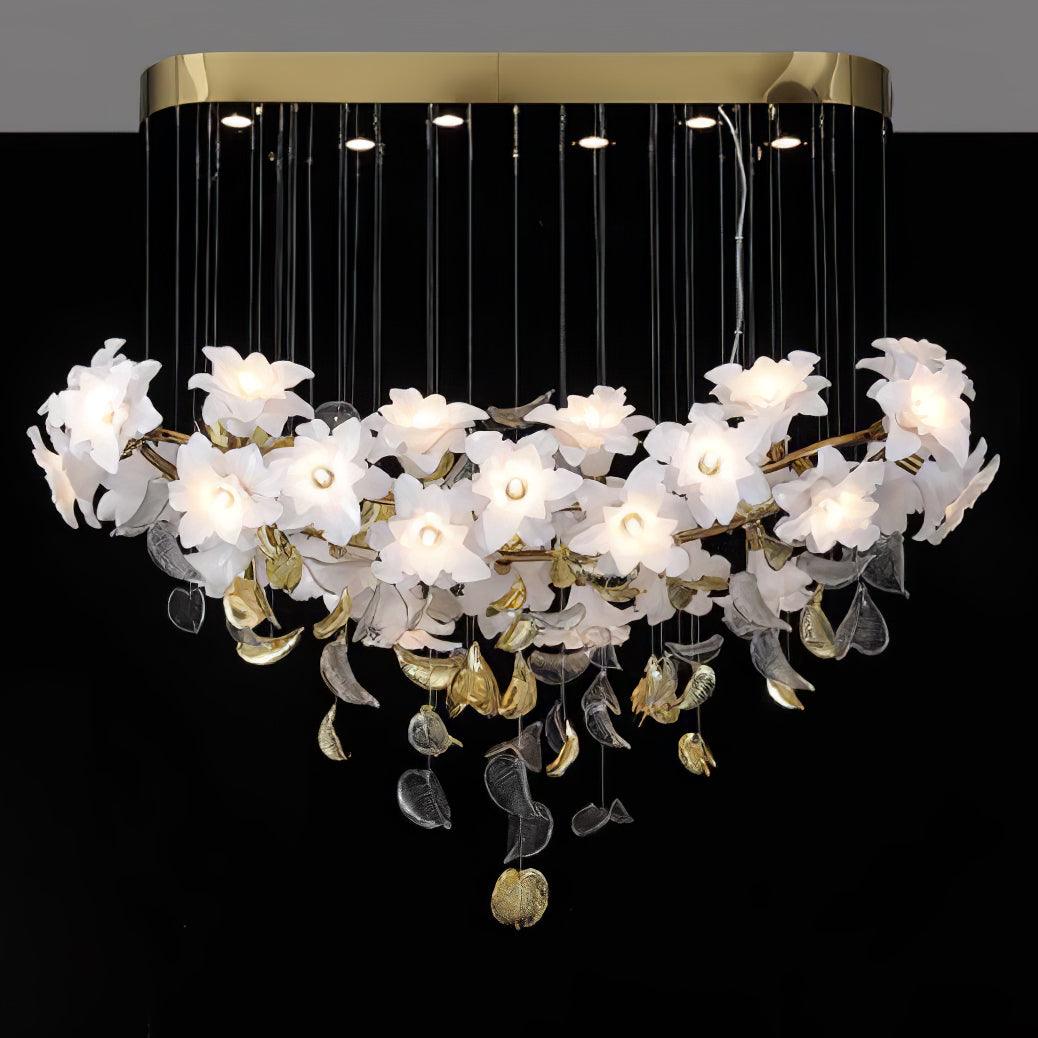 A long brass canopy with small spotlights holds this Clérachic chandelier, its row of white petal flowers lit against a black backdrop.