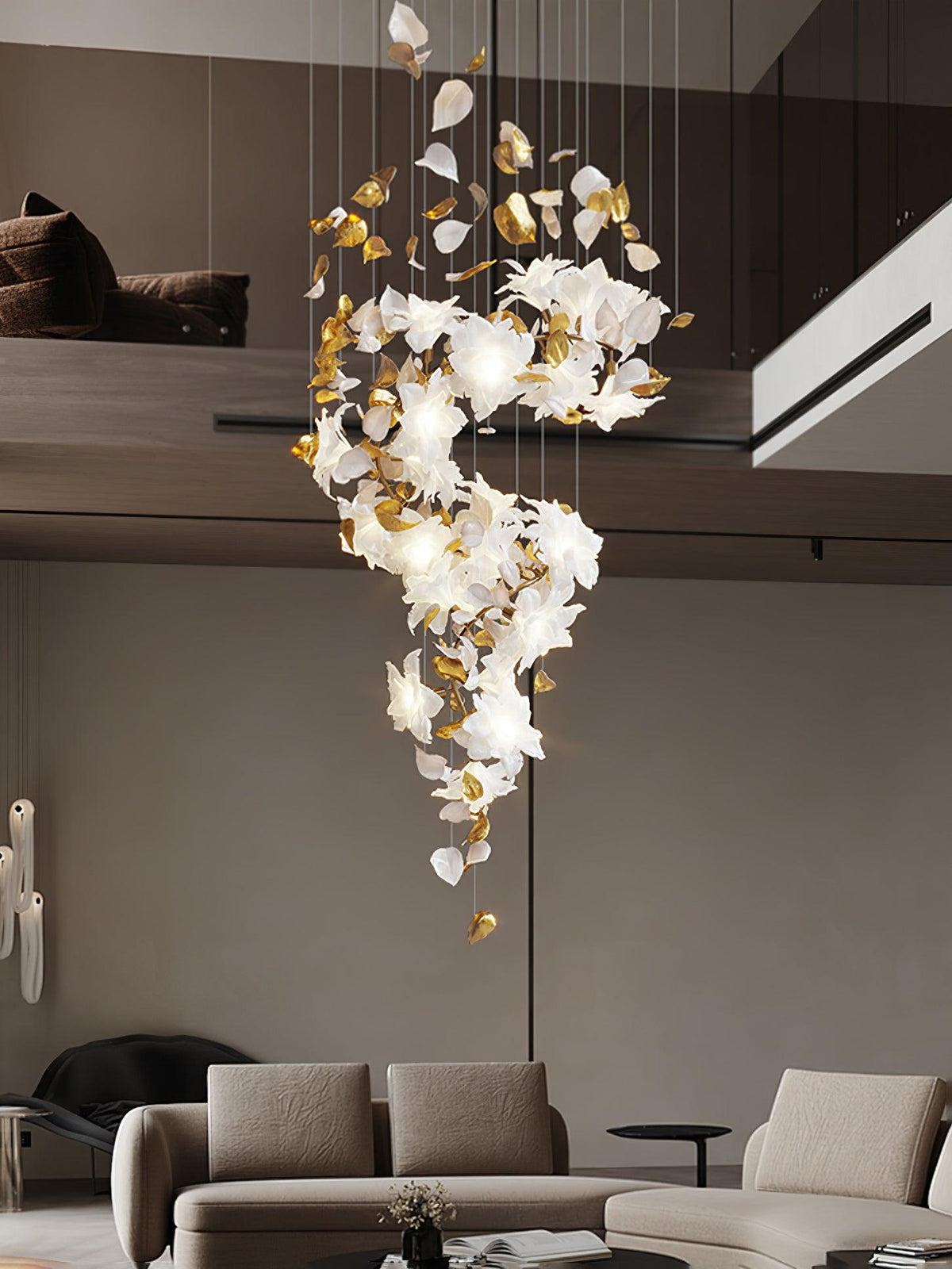 Over a low sofa in a living room with a mezzanine, this Clérachic chandelier hangs in a narrow S of white petals and gold leaves.