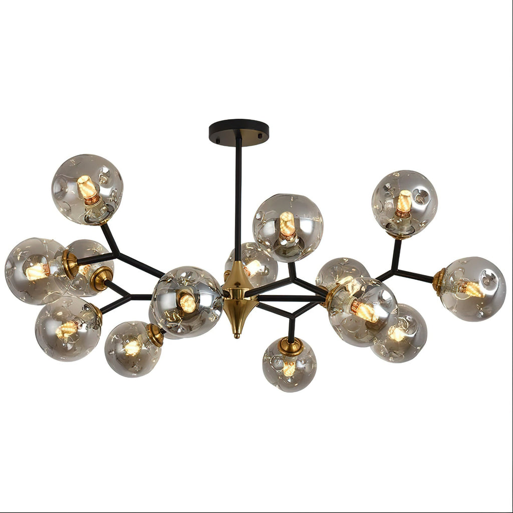 A smoky grey glass globe chandelier on black arms with a brass hub, this Clérachic ceiling light on a plain white backdrop.