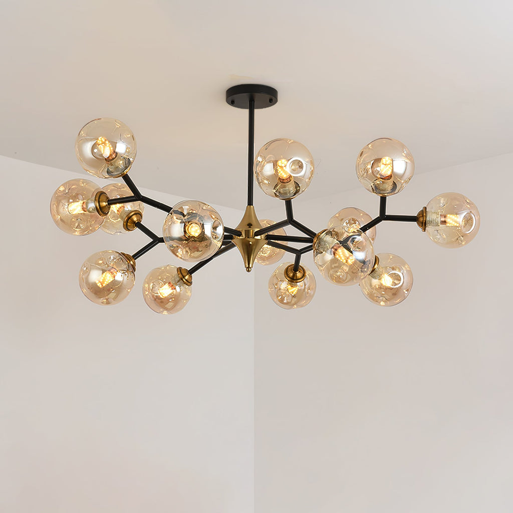 A mid-size amber Clérachic chandelier with its branches in two layers, lit, against a pale ceiling corner.