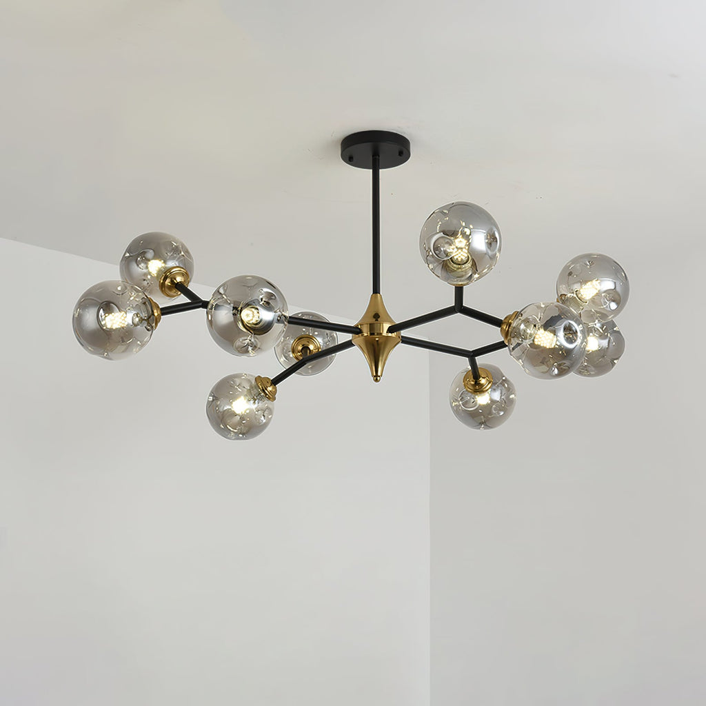 A smoky grey Clérachic chandelier with globes spread across black arms and a brass hub, lit and seen at a slight angle.