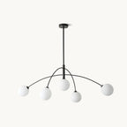 Clérachic five-globe chandelier with a black stem and curved black arms, each carrying a frosted white glass globe, on a plain white backdrop.