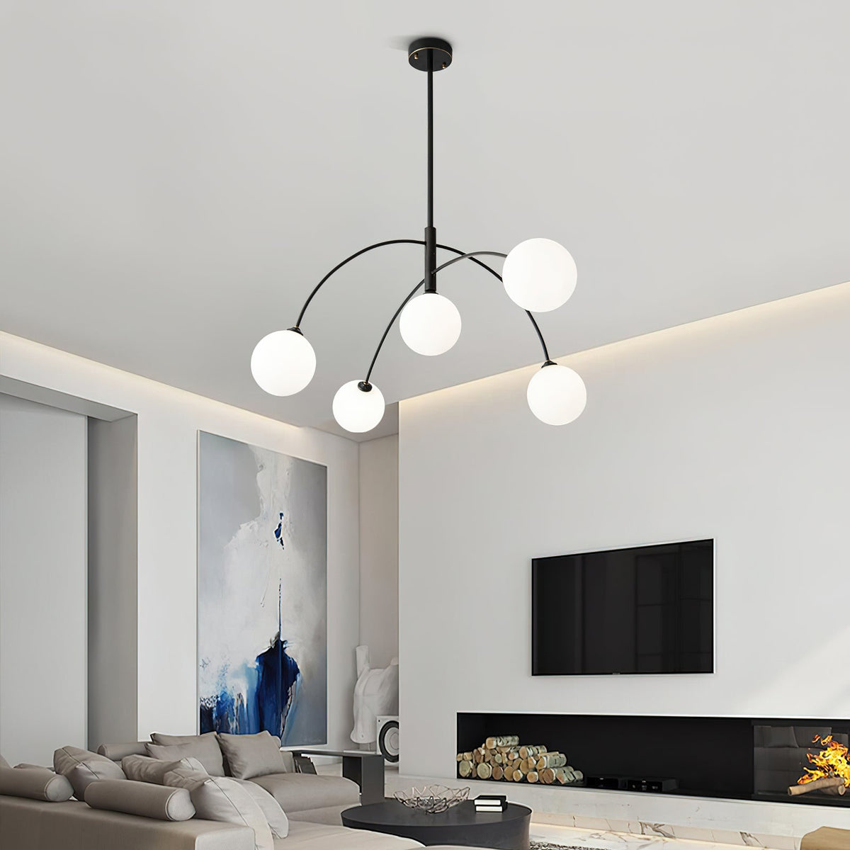 Black and white Clérachic chandelier in a lounge with a log-filled fireplace, its five frosted globes glowing.
