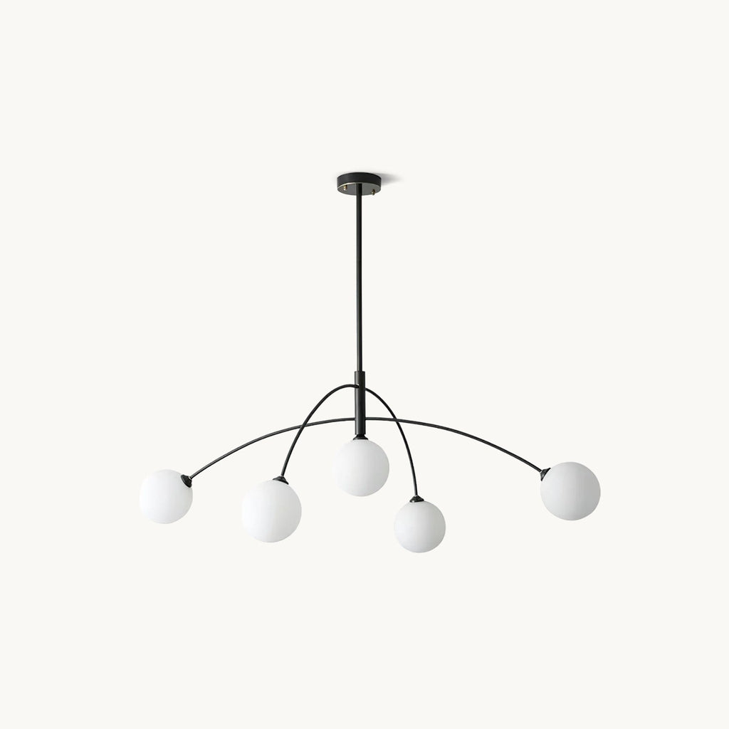 Black and white Clérachic chandelier on a soft cream backdrop, its curved arms holding five white frosted globes.