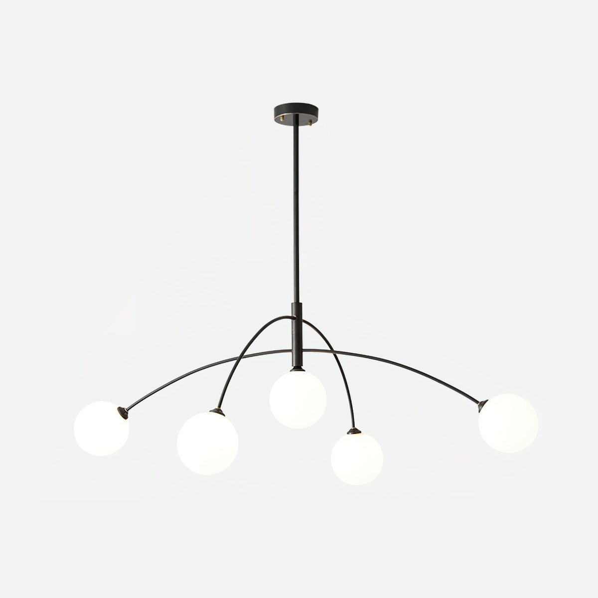 Black and white Clérachic chandelier on a pale grey backdrop, with a thin rod and five globes at different heights.