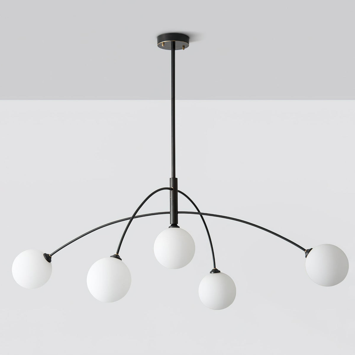 Black and white Clérachic chandelier on a pale grey ceiling and wall, seen straight on with its rod and ceiling plate.