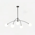 Black and white Clérachic chandelier with a black ceiling cap, lit globes and arms sweeping out to each side.