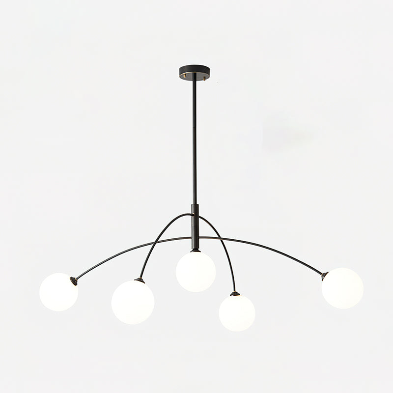 Black and white Clérachic chandelier on a light backdrop, a round ceiling plate above its rod and curved arms.