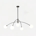 Black and white Clérachic chandelier on a light backdrop, a round ceiling plate above its rod and curved arms.