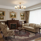 A Clérachic chandelier with white globes hangs high in a traditional living room with a brick fireplace, a tufted sofa and a patterned rug.