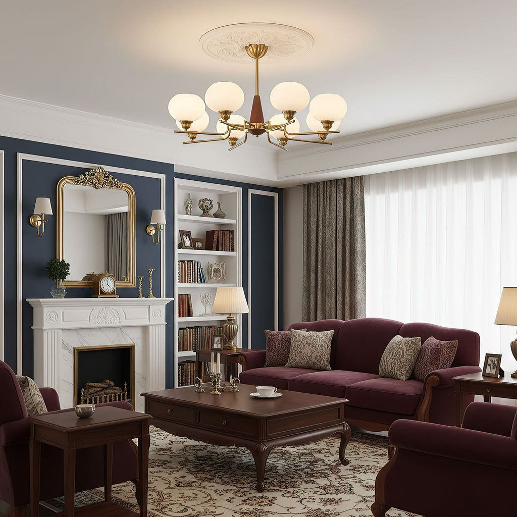In a room with navy panelling, a white fireplace and a burgundy sofa, a Clérachic chandelier hangs from a plaster ceiling rose.