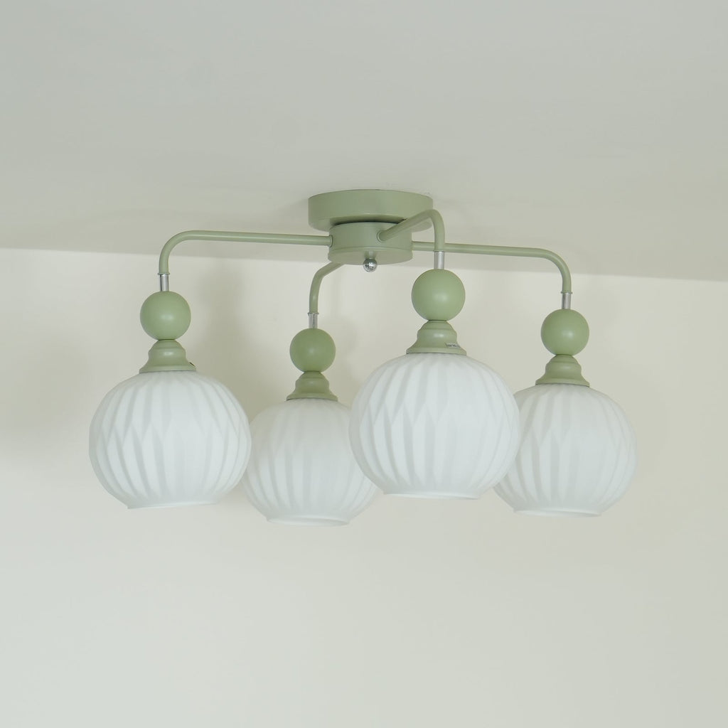 Side view of the four-globe Clérachic ceiling light, its green arms bending down from a round canopy to ribbed globes.
