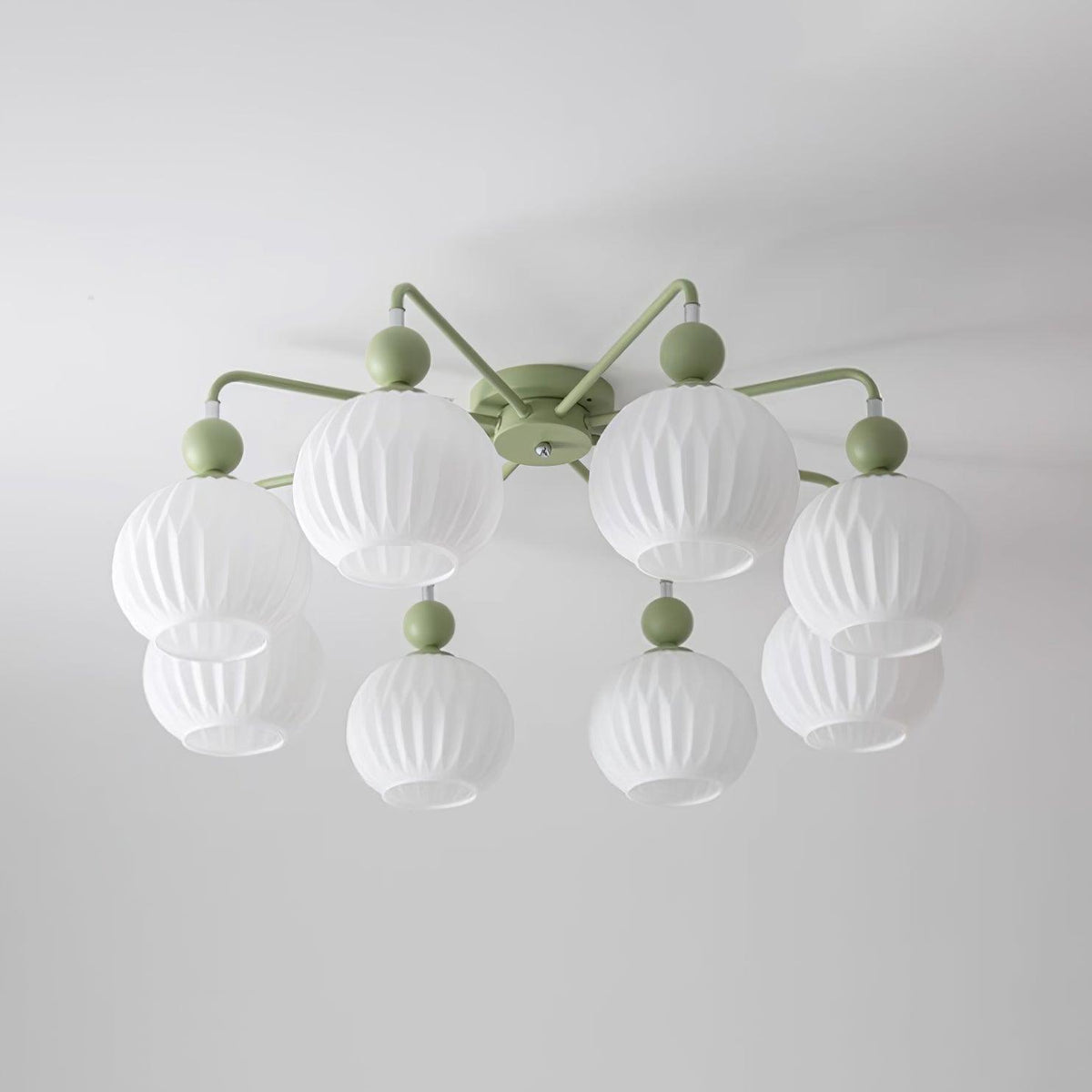 Unlit eight-globe Clérachic ceiling light in green, with two tiers of ribbed white globes on thin curved arms.