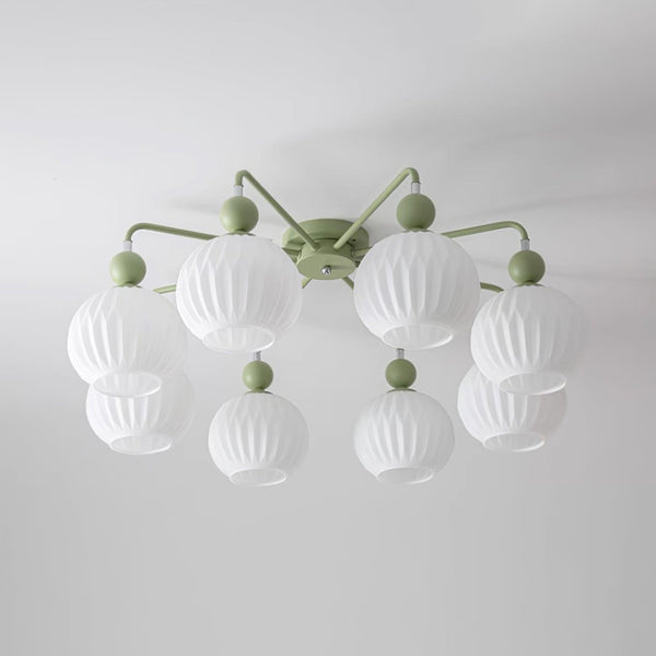 Eight-globe green Clérachic ceiling light seen from below, the ribbed white shades in two rings on a grey-white ceiling.