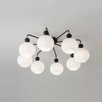 Eight-globe Clérachic ceiling light with black arms and balls, the ribbed white shades arranged in two rings.