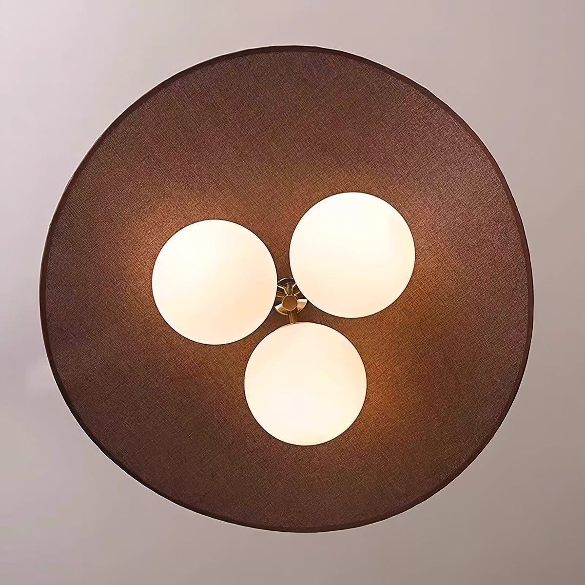 Looking up at the underside of this Clérachic pendant, with three opal globes in a triangle beneath the round, linen-textured brown shade.