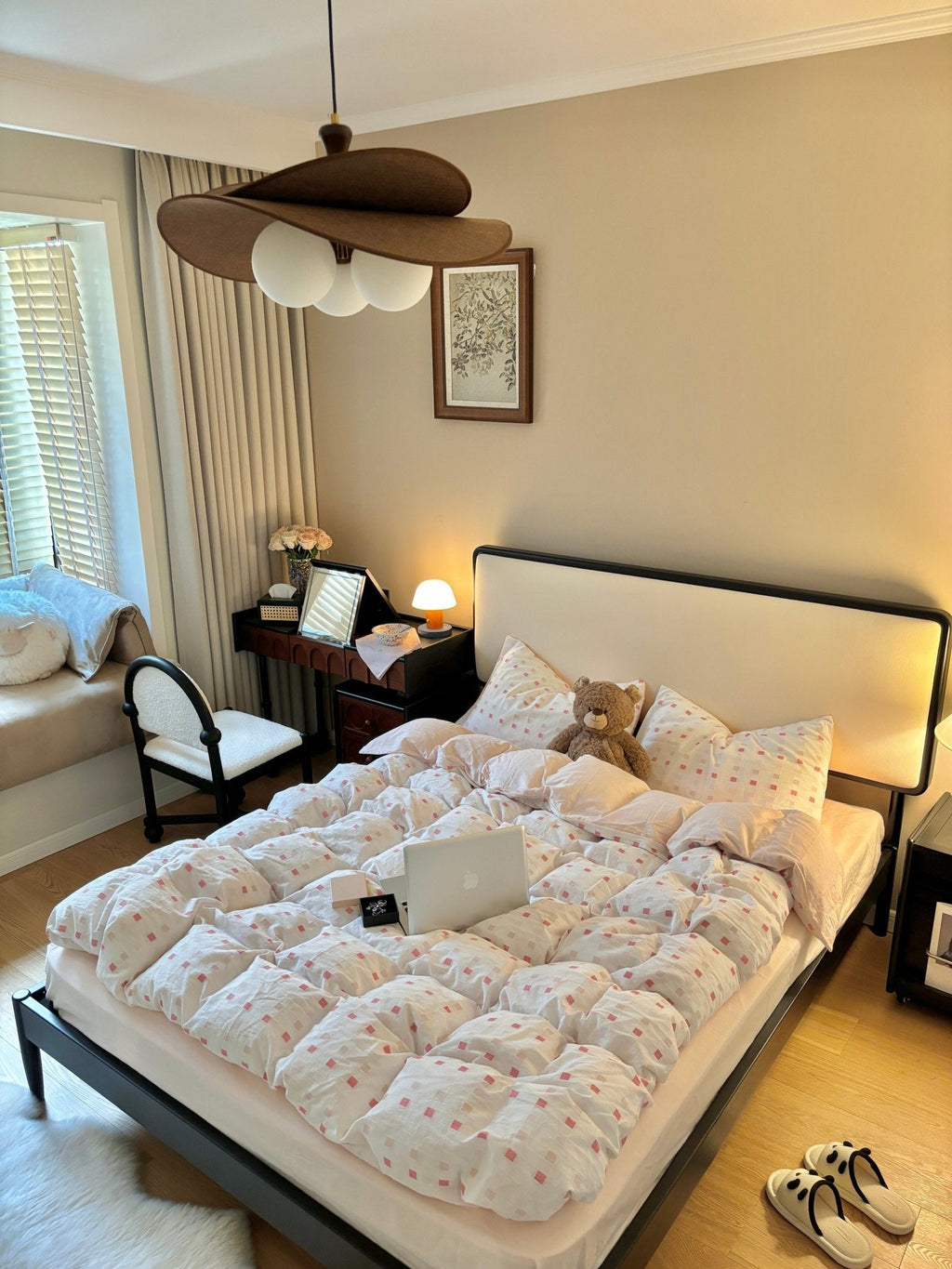 Clérachic pendant with three opal globes above a bedroom with a low black-framed bed, a small desk and a bear on the pillows.