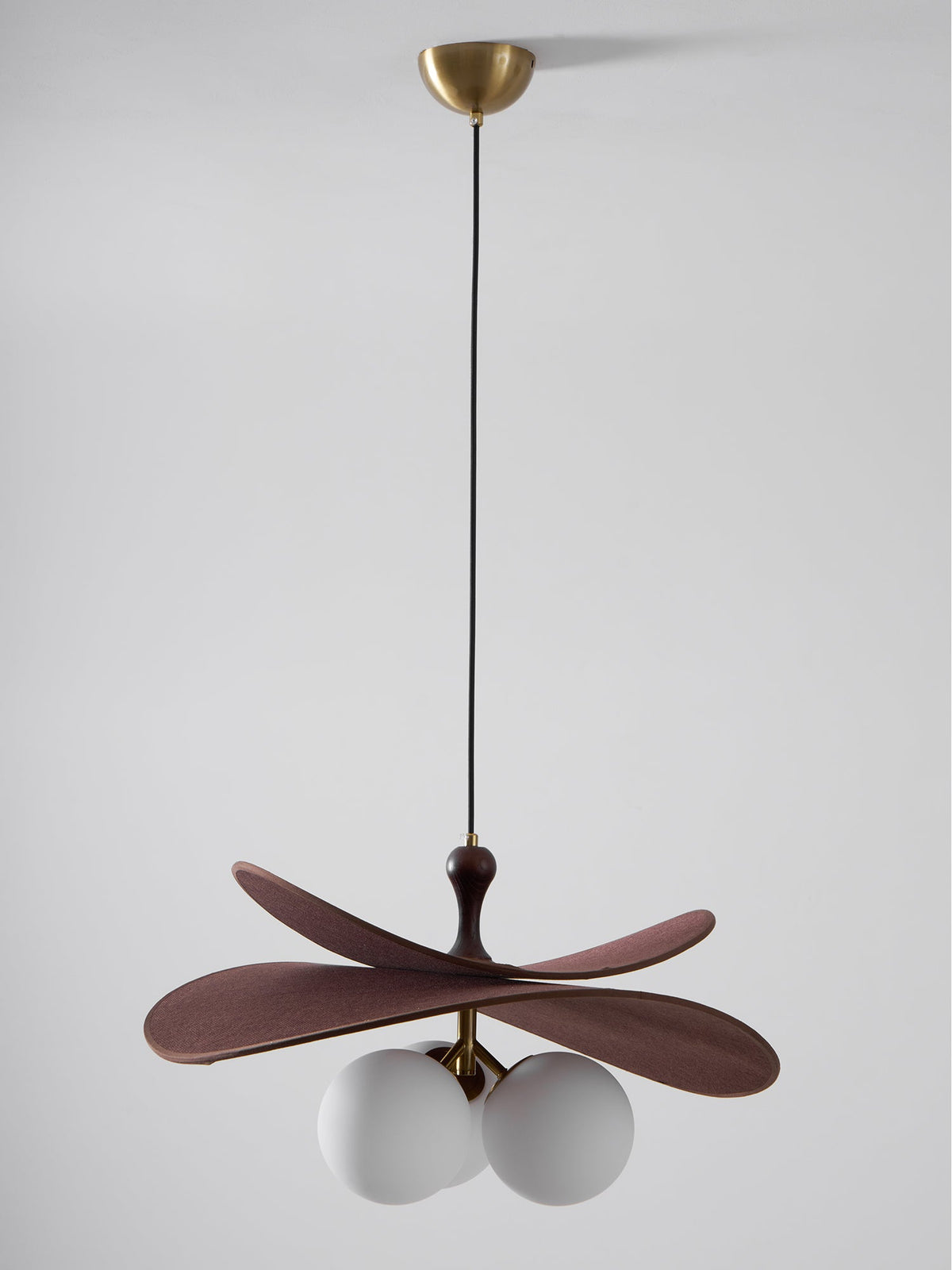 Unlit Clérachic pendant on a black cord from a brass canopy, with grey-white globes under brown fabric petals.