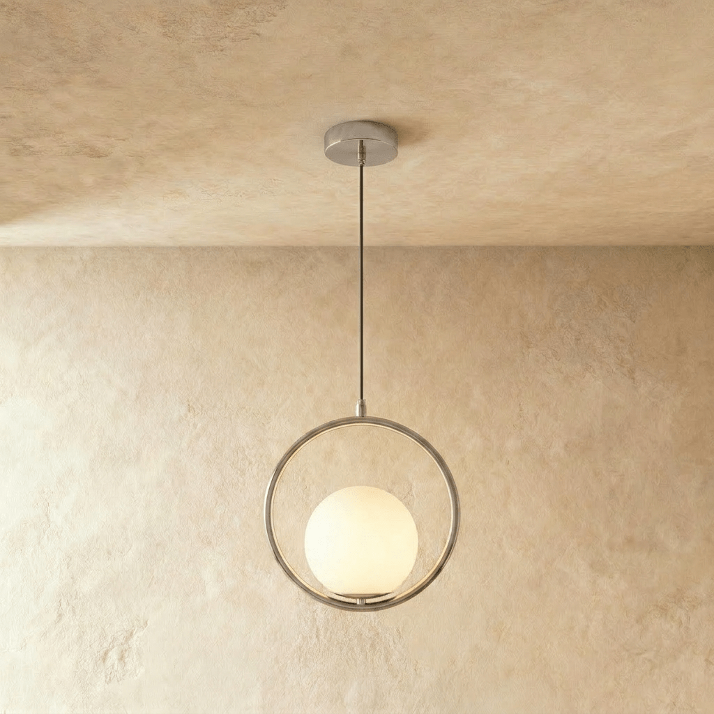 Clérachic silver ring pendant with a white opal glass globe set low in the ring, hung on a cord in a studio